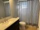 Bathroom featuring modern vanity, toilet, and shower with curtain at 2134 Victory Ave, Largo, FL 33770