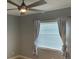 Bedroom with a ceiling fan, window with blinds, and ample natural light at 2134 Victory Ave, Largo, FL 33770