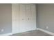 A bedroom with a closet with louvered doors and gray floors at 2134 Victory Ave, Largo, FL 33770