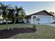 Charming single-story home featuring a well-maintained lawn and mature palm trees at 2134 Victory Ave, Largo, FL 33770