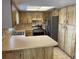 Well-lit kitchen featuring stainless steel appliances, laminate countertops, and ample cabinet space at 2134 Victory Ave, Largo, FL 33770