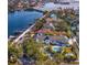 Stunning aerial view of waterfront home featuring lush landscaping, a private pool, and boat access at 2186 Coffee Pot Ne Blvd, St Petersburg, FL 33704