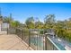 Balcony view of a backyard featuring a swimming pool, outdoor bar, and lush landscaping at 2186 Coffee Pot Ne Blvd, St Petersburg, FL 33704