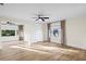 Spacious bedroom featuring hardwood floors, two windows dressed with curtains, and modern ceiling fans at 2186 Coffee Pot Ne Blvd, St Petersburg, FL 33704