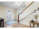 Inviting foyer with staircase, light wood floors, a decorative rug, and lots of natural light at 2186 Coffee Pot Ne Blvd, St Petersburg, FL 33704