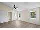 Spacious main bedroom with high ceilings, wood floors, and natural light from multiple windows at 2186 Coffee Pot Ne Blvd, St Petersburg, FL 33704