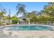 Backyard oasis with a pool, fountains, and an outdoor bar, surrounded by lush tropical foliage at 2186 Coffee Pot Ne Blvd, St Petersburg, FL 33704