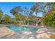 Resort-style pool area with a covered bar, perfect for entertaining in a tropical paradise at 2186 Coffee Pot Ne Blvd, St Petersburg, FL 33704