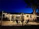 Relaxing backyard patio at night, featuring string lights and a fire pit at 2311 Wellesley, Bradenton, FL 34207