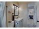 Updated bathroom featuring a modern vanity, stylish mirror and lighting fixtures, and adjacent bedroom view at 2311 Wellesley, Bradenton, FL 34207