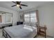 Well-lit bedroom with a mirrored closet, featuring a comfortable bed, and a side table enhancing the room's appeal at 2311 Wellesley, Bradenton, FL 34207