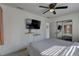 Cozy bedroom showcasing a mounted TV, mirrored closet, and shelving, blending style with practical storage solutions at 2311 Wellesley, Bradenton, FL 34207