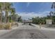 Community boat ramp leading to the water, surrounded by lush greenery and trees at 2311 Wellesley, Bradenton, FL 34207