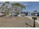 Charming blue house featuring a yellow door and a well-manicured front yard at 2311 Wellesley, Bradenton, FL 34207