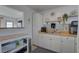 Well-lit kitchen featuring white cabinetry, butcher block counters, and decorative tile backsplash at 2311 Wellesley, Bradenton, FL 34207