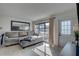 Bright living room featuring a comfortable gray sofa and natural light at 2311 Wellesley, Bradenton, FL 34207