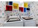 Laundry room with colorful shelving and Florida-themed wallpaper at 2413 Bayshore Blvd # 1004, Tampa, FL 33629