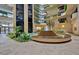 Elegant building lobby featuring a central fountain and lush tropical plants at 2413 Bayshore Blvd # 1004, Tampa, FL 33629