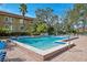 Inviting community pool with lounge chairs and lush landscaping at 2413 Bayshore Blvd # 1004, Tampa, FL 33629