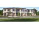 Front view of townhouses with attached garages and landscaping at 2637 Sunray Venus Way, Ruskin, FL 33570