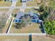 Aerial view of blue home with solar panels, white fence, and landscaping at 2653 Cover Ln, North Port, FL 34286