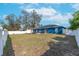 Spacious backyard featuring a white fence and a patio area with outdoor seating at 2653 Cover Ln, North Port, FL 34286