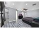 Spacious bedroom featuring stylish gray walls, modern ceiling fan, and sleek gray wood-look floors at 2653 Cover Ln, North Port, FL 34286