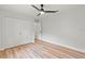 Well-lit bedroom with double doors and hardwood flooring at 2717 Briarpatch Dr, Valrico, FL 33596