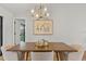 Bright dining room with modern light fixture and wood table at 2717 Briarpatch Dr, Valrico, FL 33596