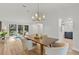 Dining room with hardwood floors, chandelier, and access to the backyard at 2717 Briarpatch Dr, Valrico, FL 33596