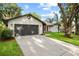 Updated home exterior boasts a two-car garage and landscaped lawn at 2717 Briarpatch Dr, Valrico, FL 33596