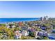 Picturesque aerial image of a property surrounded by lush trees, bay access, and city skyline views at 2907 W Euclid Ave, Tampa, FL 33629