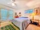 Bright bedroom featuring a ceiling fan, french doors with blinds, and modern decor at 2907 W Euclid Ave, Tampa, FL 33629