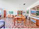 Open dining room showcasing mosaic tile floors, wood furniture, and eclectic decor at 2907 W Euclid Ave, Tampa, FL 33629