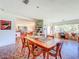 Open dining room with a wood table, colorful chairs, unique flooring, and a large window view at 2907 W Euclid Ave, Tampa, FL 33629