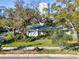 Charming single-story home with lush landscaping and mature trees offering curb appeal and shade at 2907 W Euclid Ave, Tampa, FL 33629