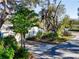 View of the home's exterior showing the driveway with two-car garage and mature, tropical landscaping at 2907 W Euclid Ave, Tampa, FL 33629