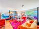 Bright living room featuring a vibrant rug, colorful furniture, and natural light at 2907 W Euclid Ave, Tampa, FL 33629