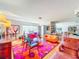 Eclectic living room featuring vibrant furniture, a large window, and an open floor plan at 2907 W Euclid Ave, Tampa, FL 33629