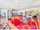 Bright living room featuring colorful furniture, a large window, and a connected dining area at 2907 W Euclid Ave, Tampa, FL 33629