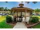 Enclosed community gazebo featuring seating, providing a comfortable space for gatherings at 3377 Crystal E Ct # E, Palm Harbor, FL 34685