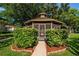 Community gazebo surrounded by lush greenery, offering a peaceful spot for residents at 3377 Crystal E Ct # E, Palm Harbor, FL 34685