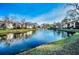 Scenic pond view with fountain, surrounded by well-maintained lawns and apartment buildings at 3377 Crystal E Ct # E, Palm Harbor, FL 34685