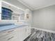 Bright bathroom with modern vanity, square sink, framed mirror, and luxury vinyl tile flooring at 3663 Berger Rd, Lutz, FL 33548