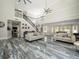 Spacious living room with high ceilings, a staircase with decorative ironwork and large marbled floors at 3663 Berger Rd, Lutz, FL 33548