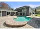 Inviting kidney-shaped pool with brick pavers and lounge chairs at 3663 Berger Rd, Lutz, FL 33548