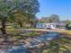 Manufactured home with large backyard and surrounding trees at 3749 Loury Dr, Wesley Chapel, FL 33543