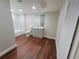 Modern bathroom with grey vanity, white tile, and wood-look flooring at 3749 Loury Dr, Wesley Chapel, FL 33543