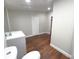 Clean bathroom with grey vanity, toilet and wood-look flooring at 3749 Loury Dr, Wesley Chapel, FL 33543