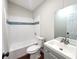 Clean bathroom with white tile and grey vanity at 3749 Loury Dr, Wesley Chapel, FL 33543